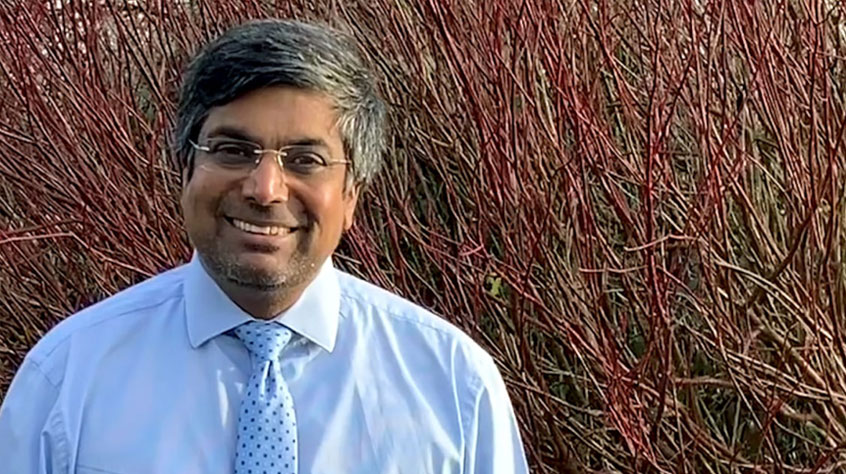 Vice chancellor Nishan Canagarajah looking into the camera and smiling.