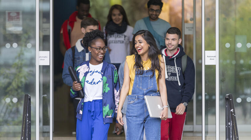 Students walking, chatting and smiling