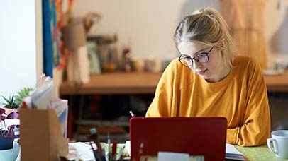 student using laptop on desk