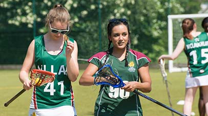 students in hockey kit on field