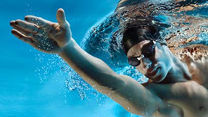 young man swimming in swimming pool