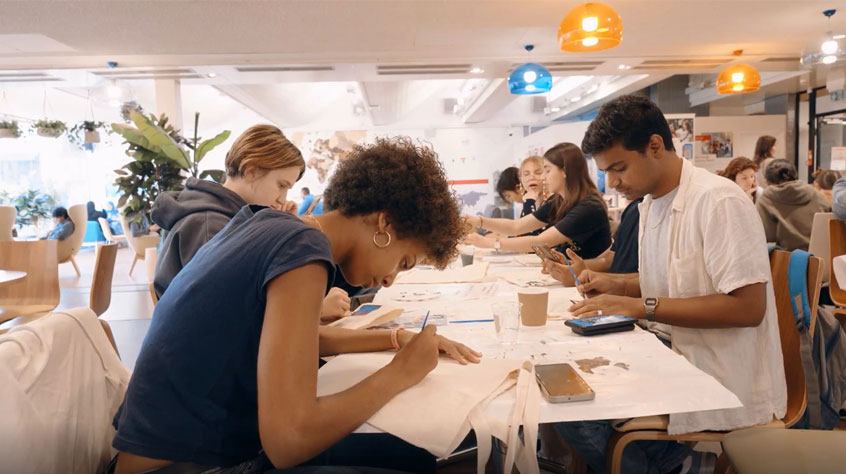 People looking down at the table and painting their own items.