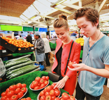 Students shopping for tomatoes at Leicester Market