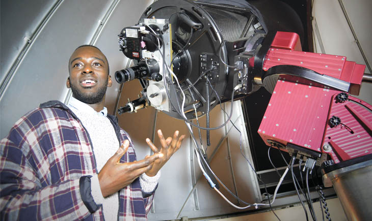 Student using a telescope at the University of Leicester Observatory
